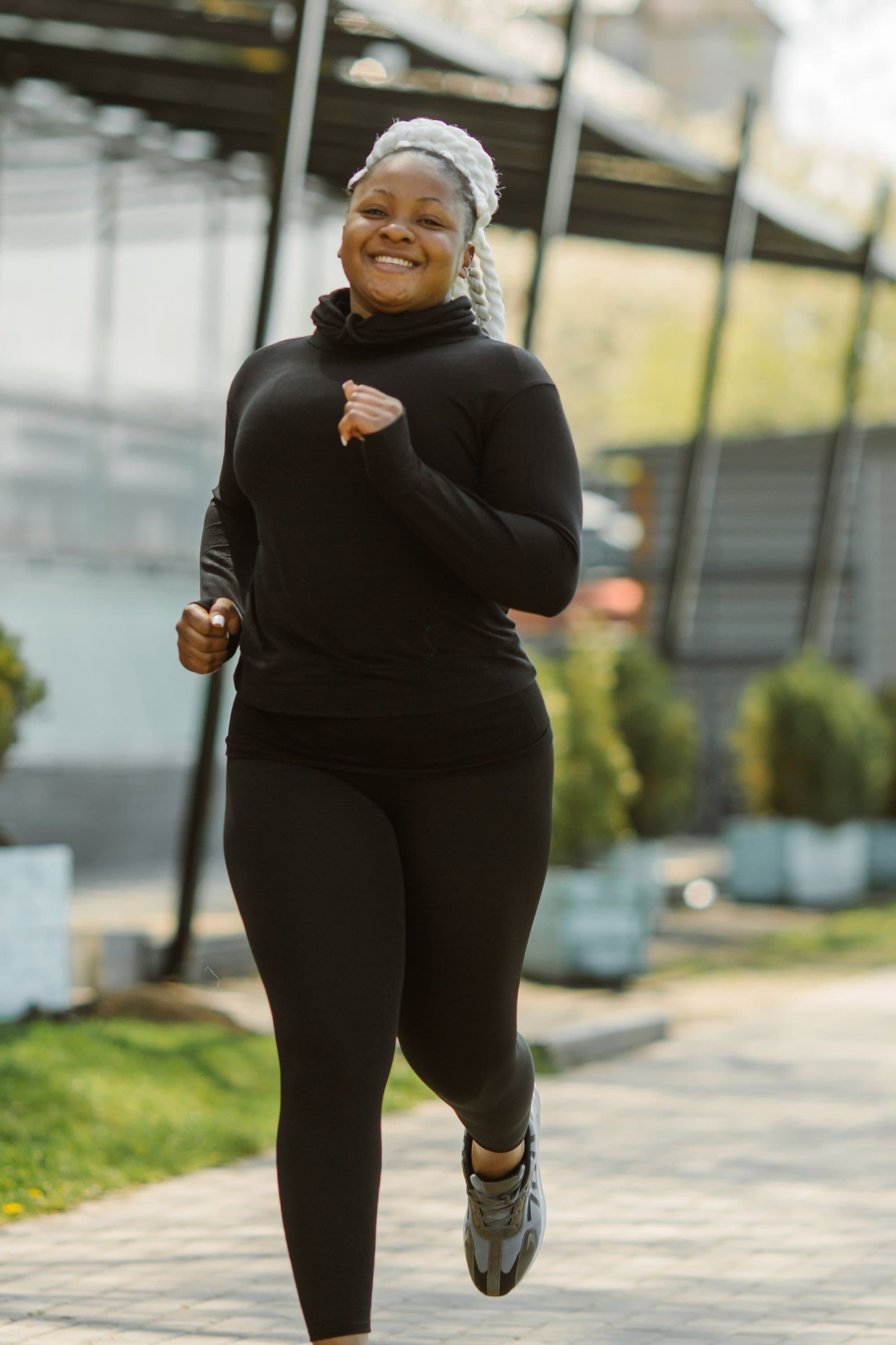 Smiling woman jogging outdoors